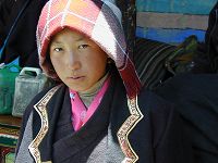 A young Tibetan woman visiting to watch the religious dance.